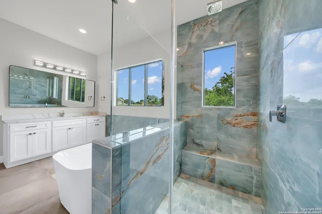 a bathroom with a sink a toilet and mirror