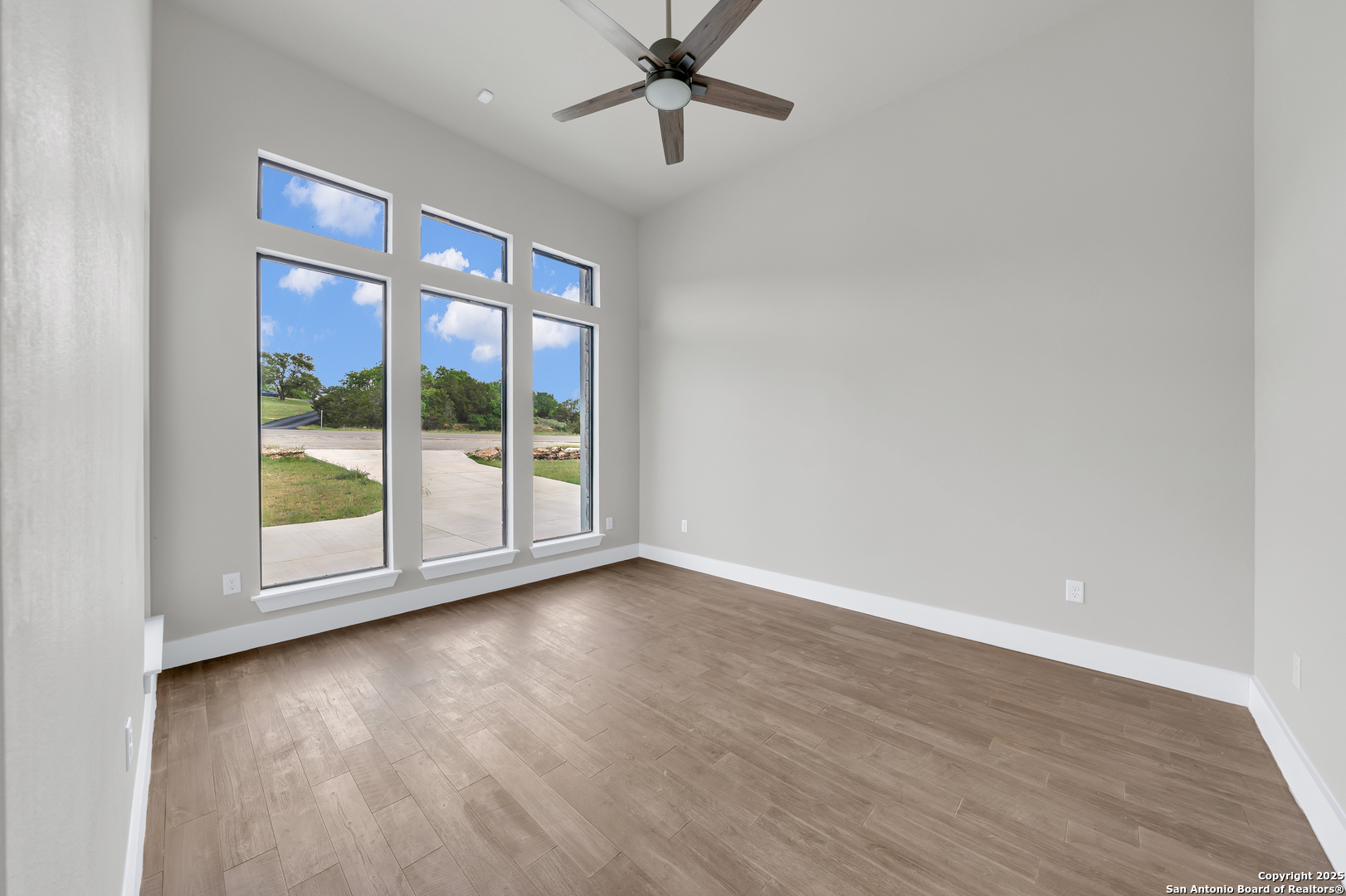 6846 Spring Branch Road Spring Branch, TX 78070 - Photo 36 of 46 wooden floor in an empty room with a window