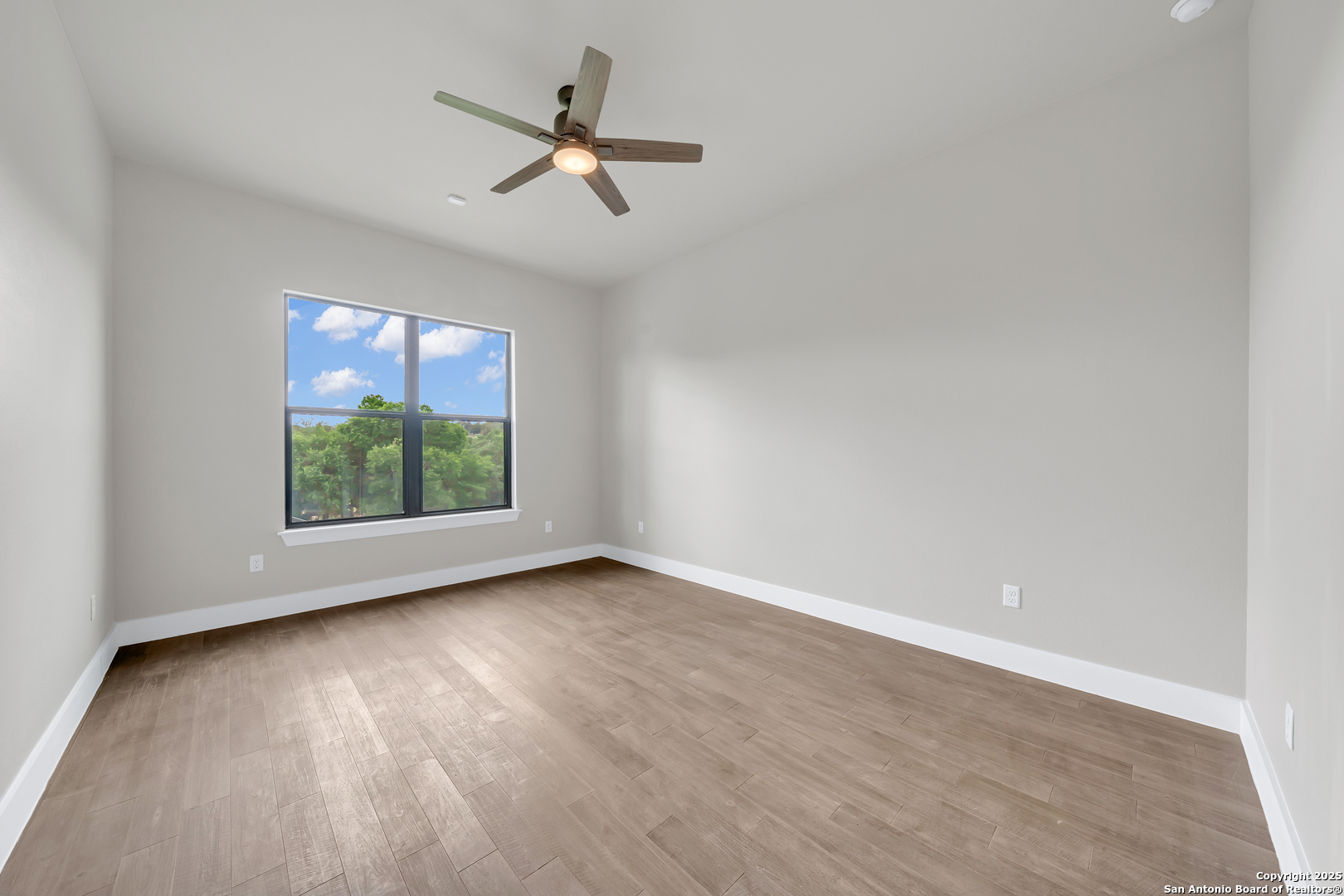 6846 Spring Branch Road Spring Branch, TX 78070 - Photo 38 of 46 wooden floor in an empty room with a window