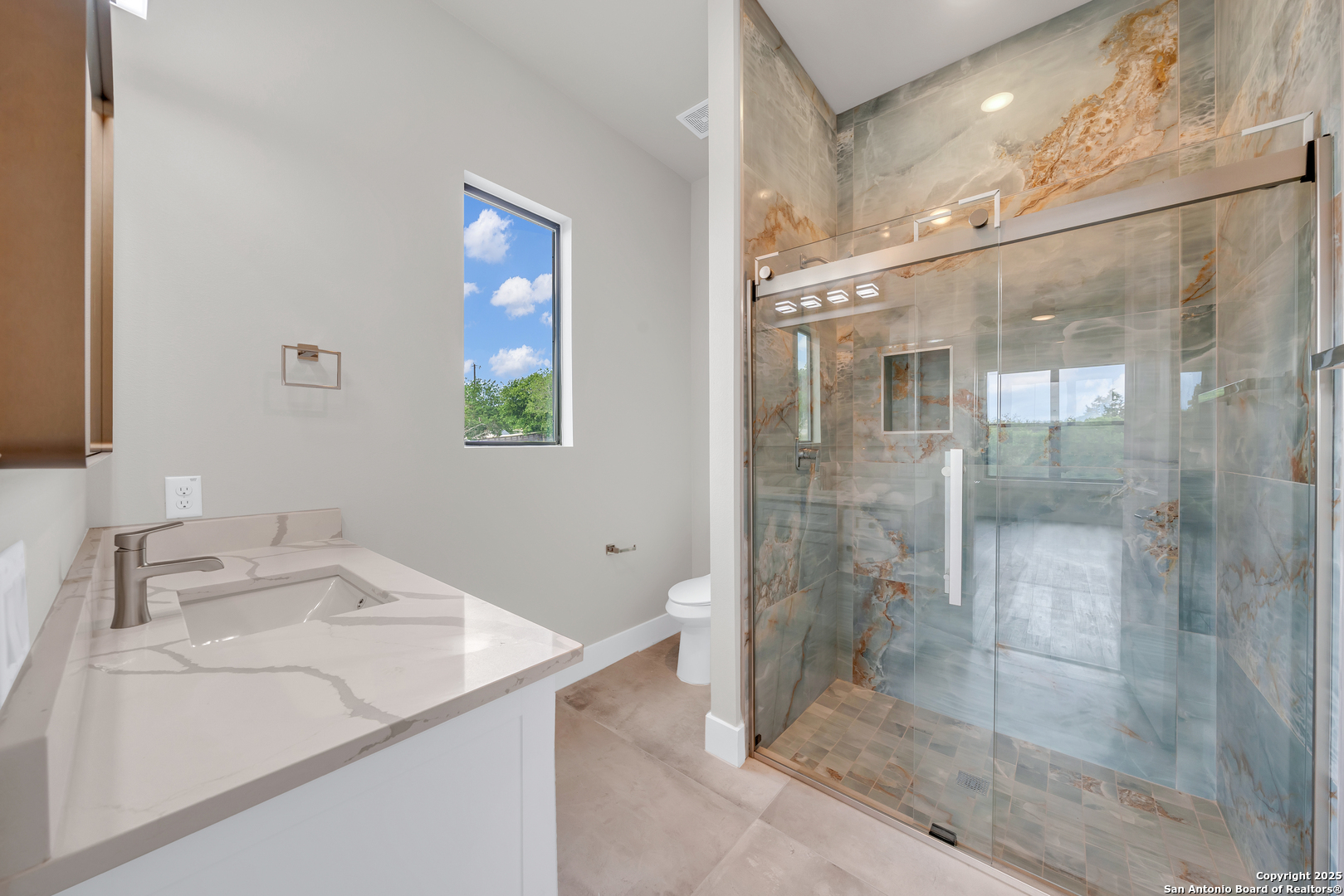 6846 Spring Branch Road Spring Branch, TX 78070 - Photo 39 of 46 a bathroom with a granite countertop sink a shower and mirror