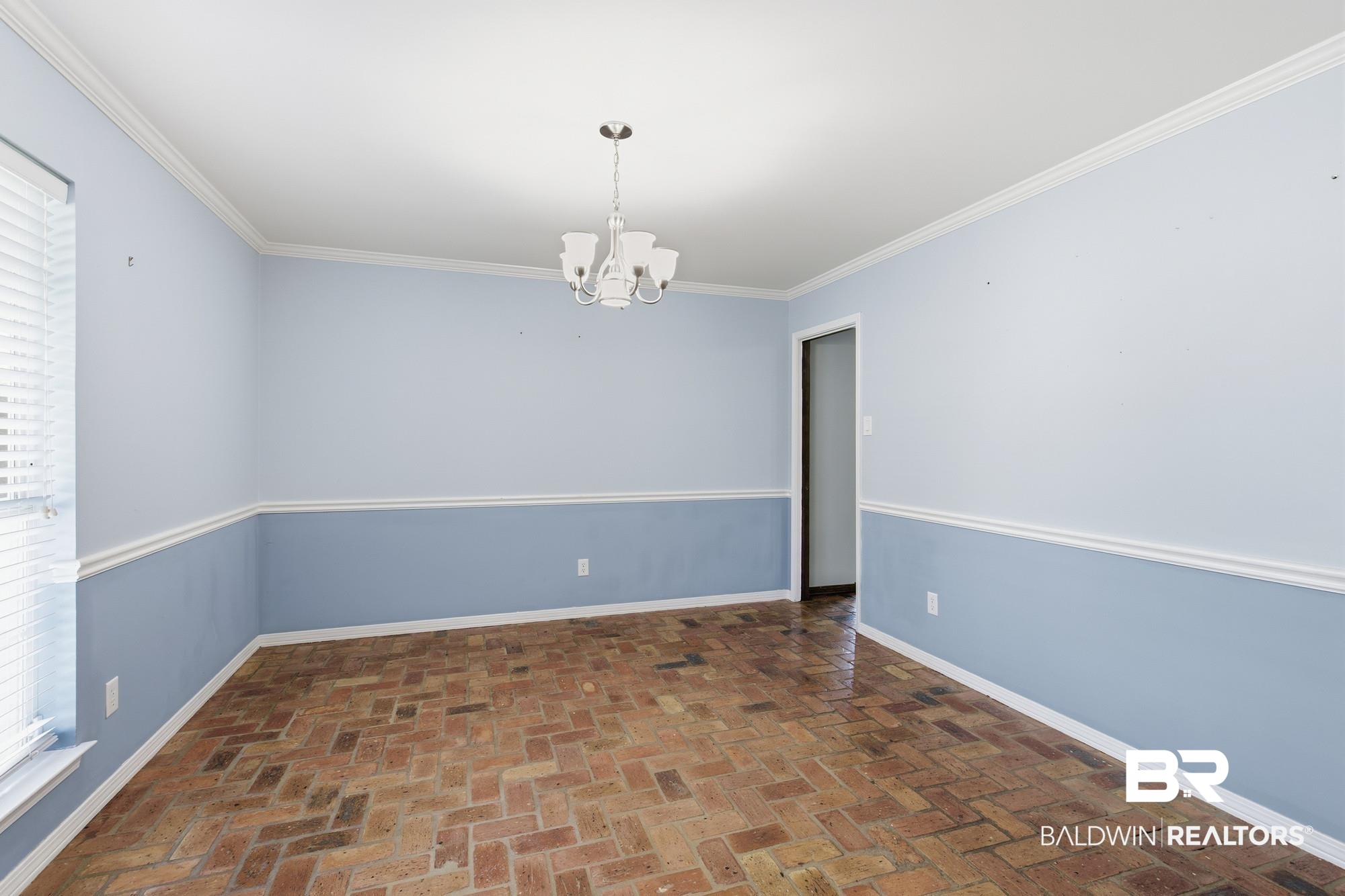 9215 Shiloh Drive Mobile, AL 36695 - Photo 10 of 32 Spare room featuring a chandelier, ornamental molding, brick floors, and healthy amount of natural light