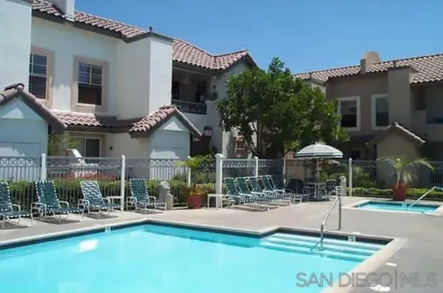 a swimming pool with outdoor seating and yard