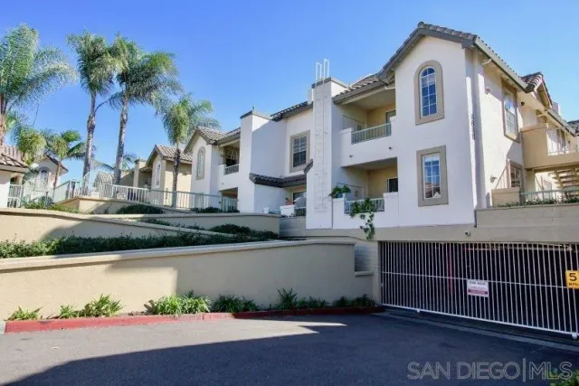 a front view of a house with a yard and potted plants