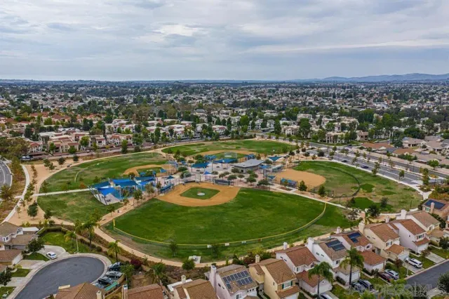 an aerial view of a residential houses with outdoor space