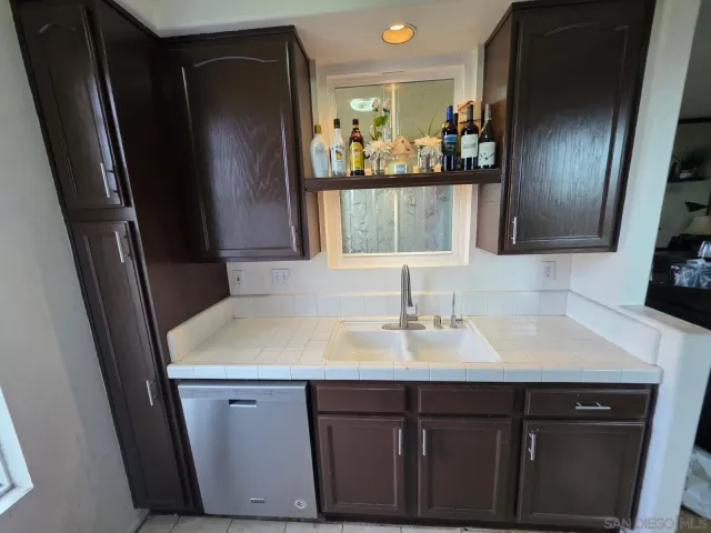 a kitchen with a sink and refrigerator
