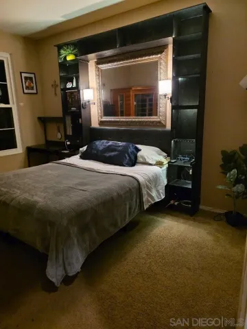 a bedroom with a bed and a mirror