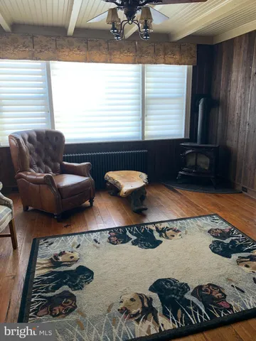 a spacious bedroom with a bed and a flat screen tv