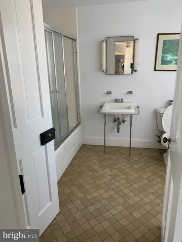 a bedroom with a bed and a wooden floor