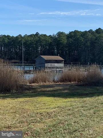 a view of a lake with a yard and mountain view