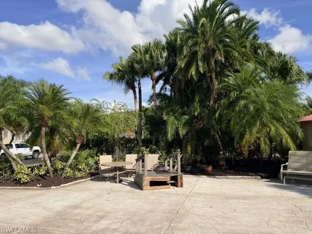 a view of outdoor space with seating area and trees