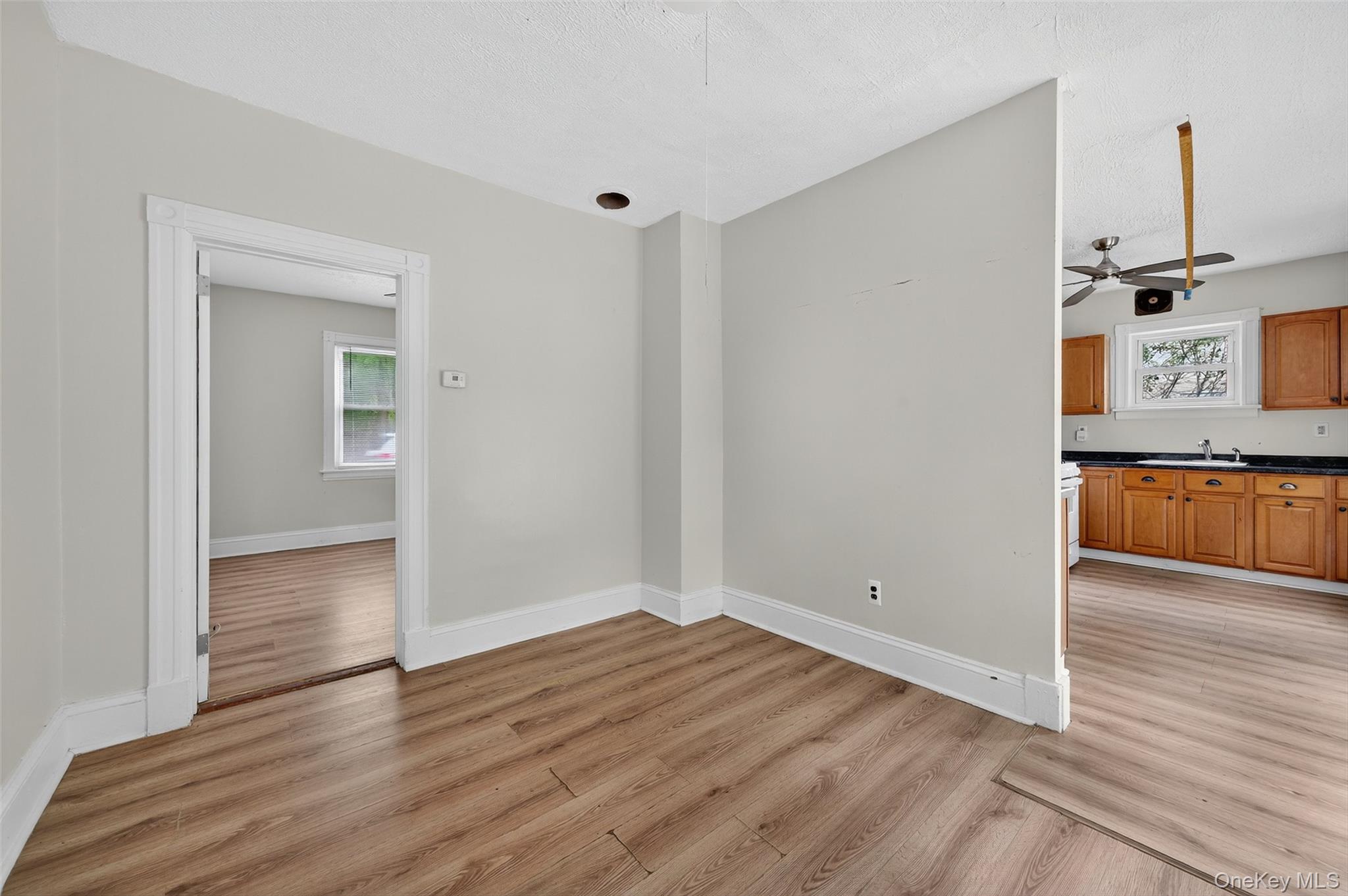 72 Smith Clove Road Central Valley, NY 10917 - Photo 12 of 35 Unfurnished dining area featuring light wood-type flooring, ceiling fan, and a textured ceiling