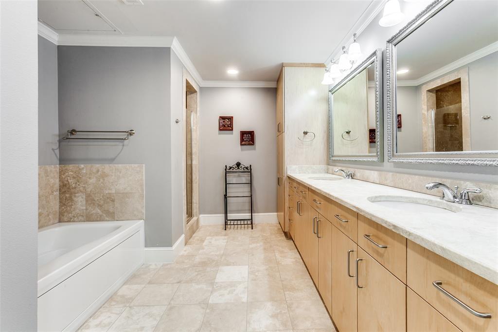 5055 Addison Circle, Unit 205 Addison, TX 75001 - Photo 18 of 24 Dual sinks, storage, linen closet, travertine tile.