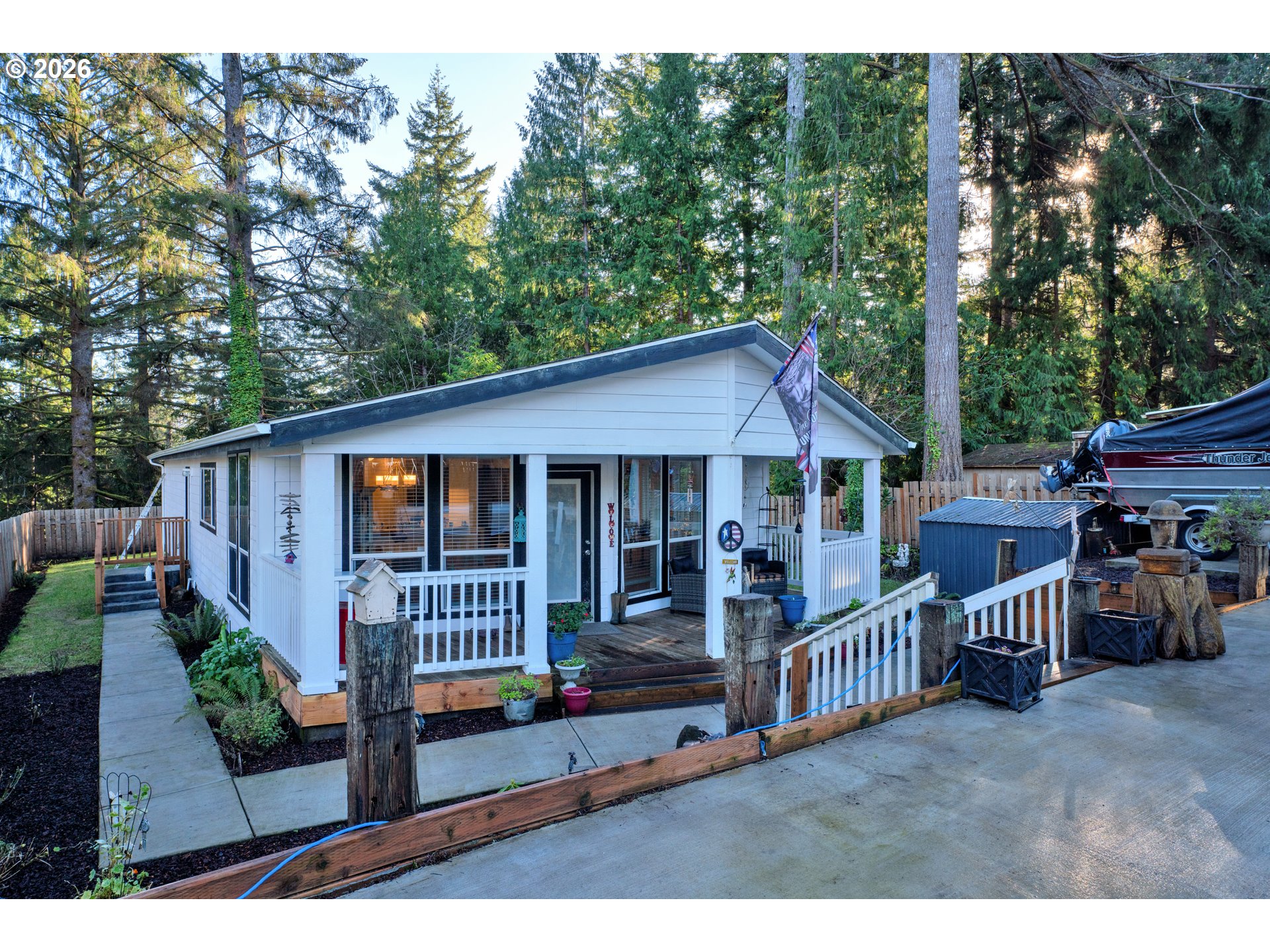 a view of a house with a deck and furniture