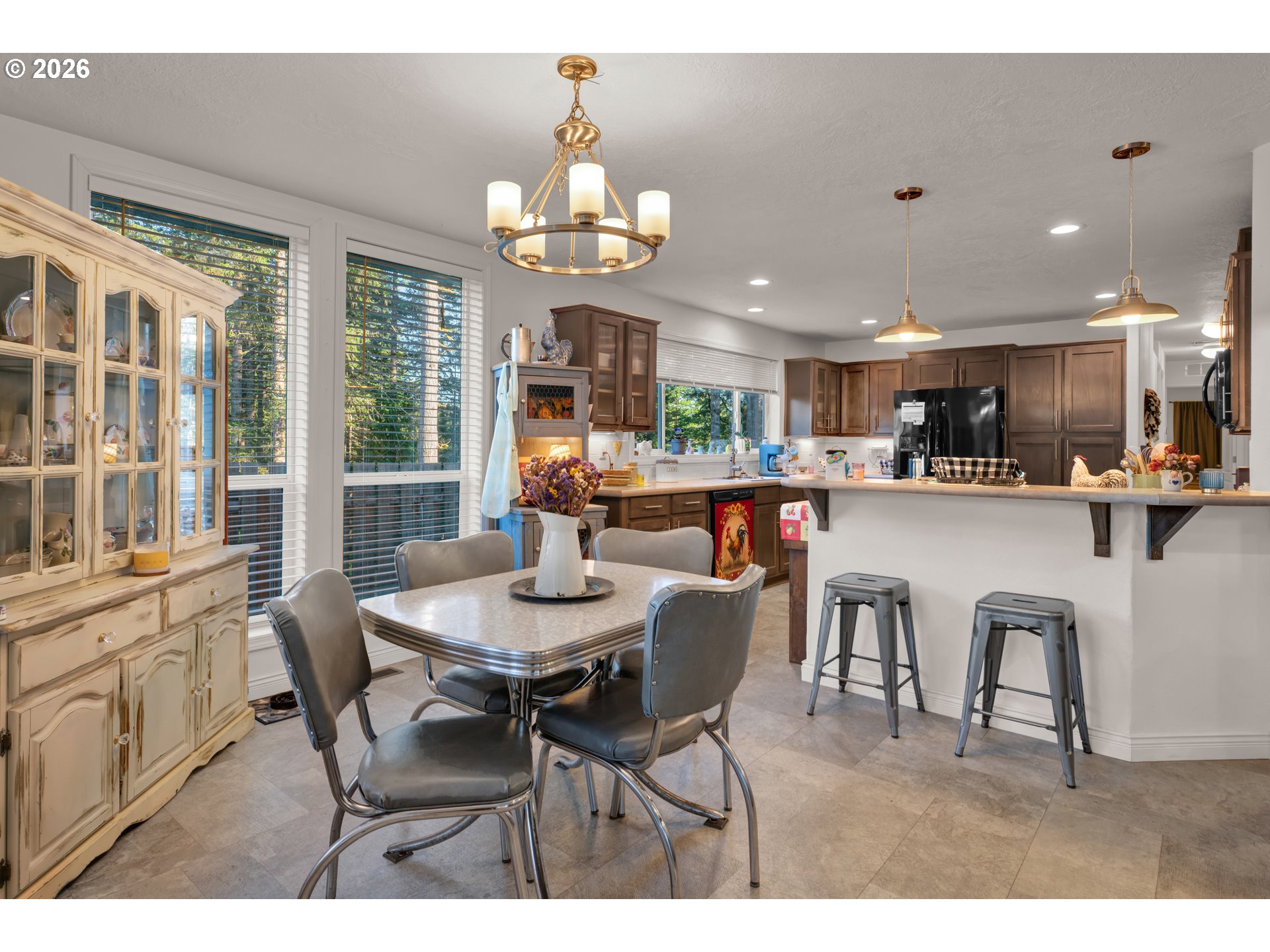 89555 Shorecrest Drive Florence, OR 97439 - Photo 11 of 24 a dining room with stainless steel appliances kitchen island granite countertop a dining table chairs and a kitchen view