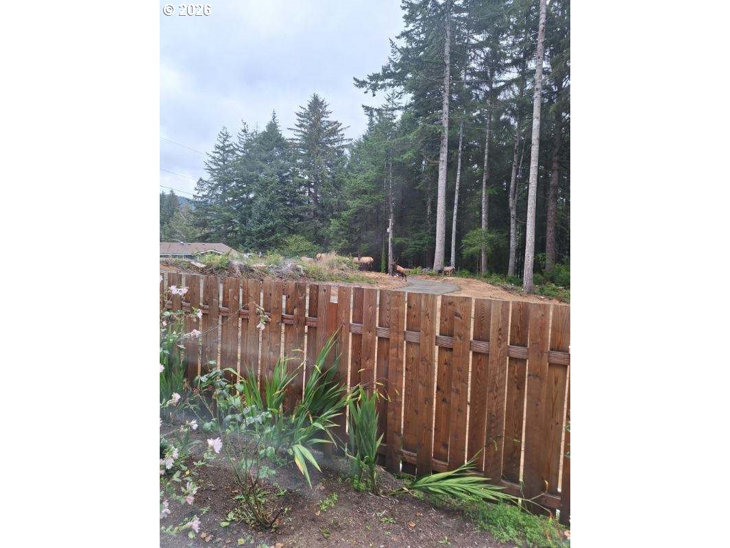 89555 Shorecrest Drive Florence, OR 97439 - Photo 23 of 24 a view of a wooden fence with a big yard