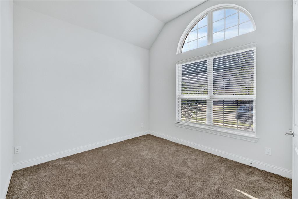 2307 Sam Street Mansfield, TX 76063 - Photo 4 of 23 Spare room featuring lofted ceiling and dark colored carpet