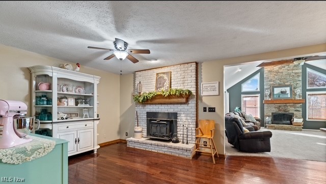 8995 Ridge Road Wooster, OH 44691 - Photo 24 of 50 Living room featuring a fireplace, ceiling fan, a textured ceiling, dark wood finished floors, and lofted ceiling