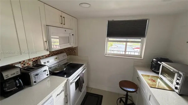 a kitchen with a stove and a microwave