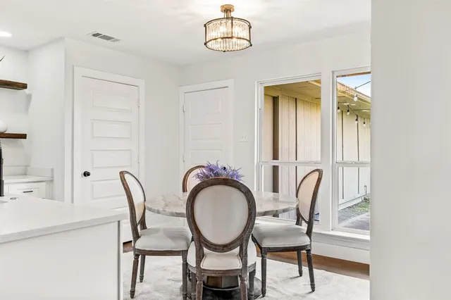 a view of a room with furniture and wooden floor