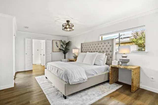 a bedroom with a bed and wooden floor