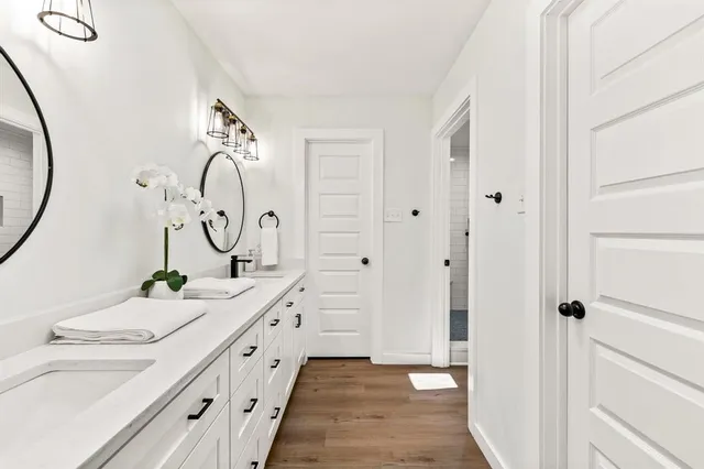 a bathroom with a double vanity sink and a mirror