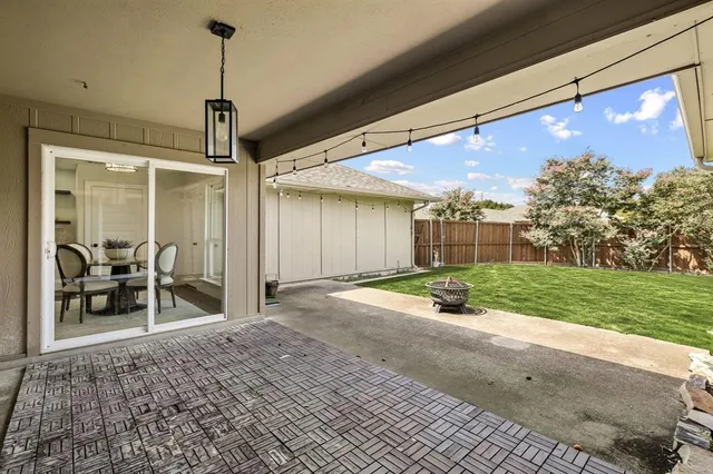 a patio with table and chairs