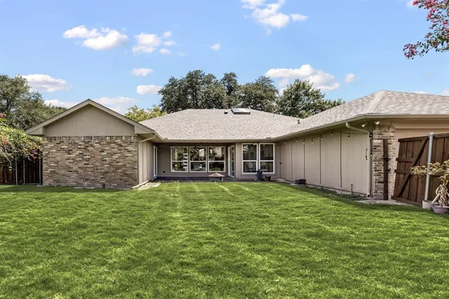 a view of a house with a yard and sitting area