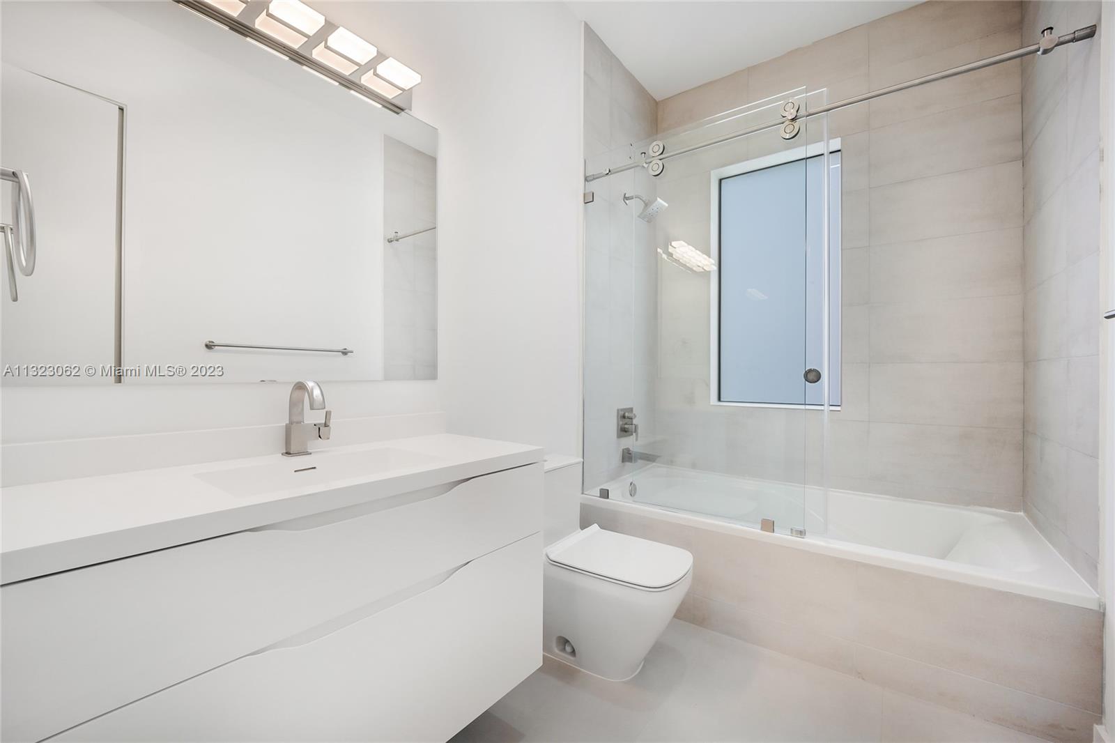 442 Southwest 15th Road Miami, FL 33129 - Photo 14 of 18 a bathroom with a bathtub shower sink vanity and toilet