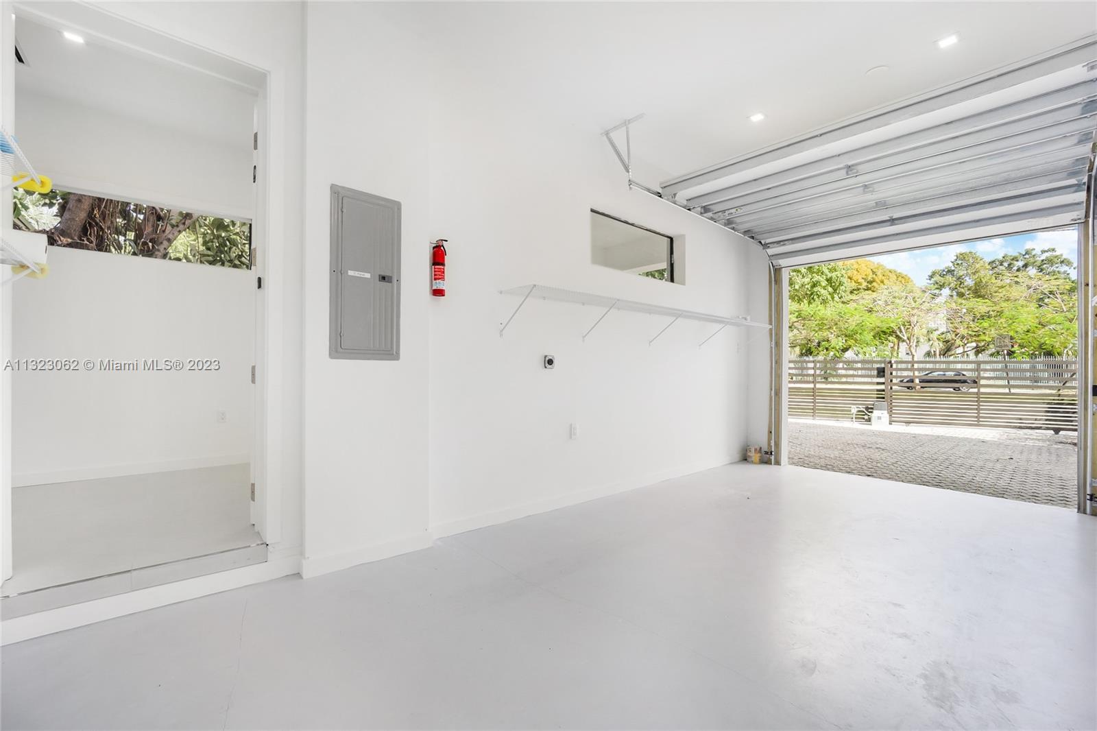 442 Southwest 15th Road Miami, FL 33129 - Photo 17 of 18 an empty room with windows and view of kitchen