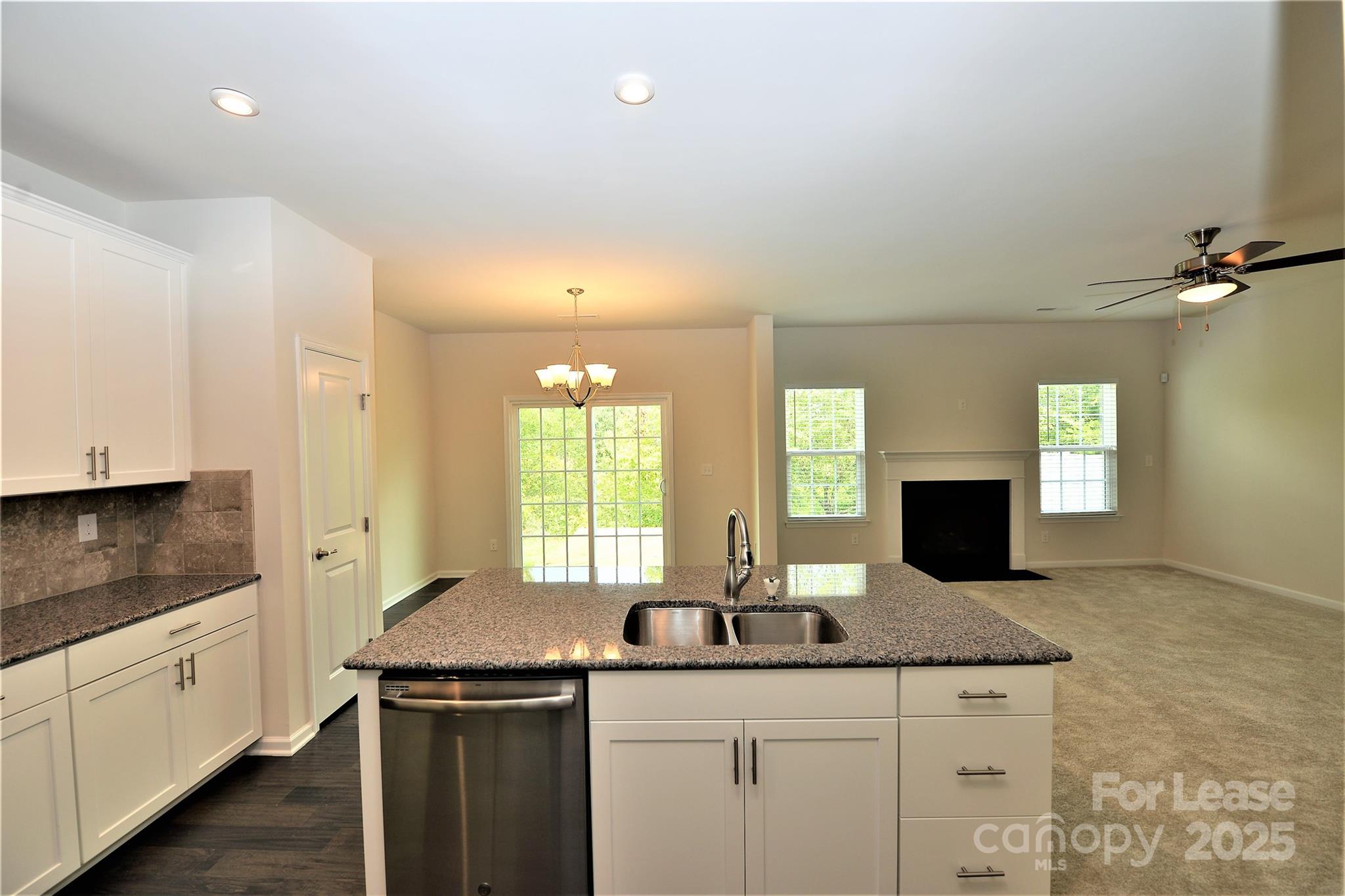 2829 Sand Cove Court Denver, NC 28037 - Photo 11 of 31 a kitchen with granite countertop a sink and cabinets
