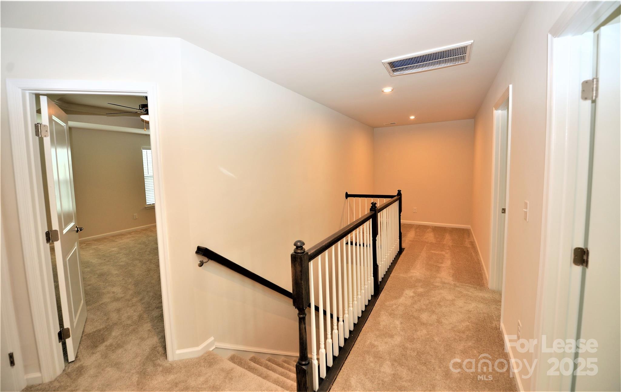 2829 Sand Cove Court Denver, NC 28037 - Photo 17 of 31 a view of a hallway with wooden floor and staircase