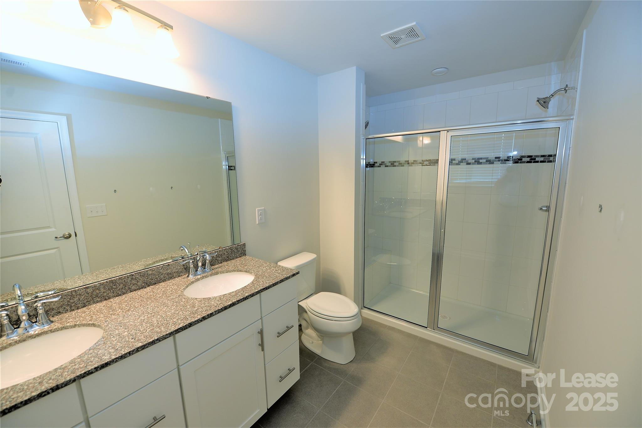 2829 Sand Cove Court Denver, NC 28037 - Photo 29 of 31 a bathroom with a granite countertop sink toilet and shower