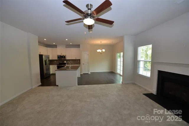 a view of kitchen with kitchen island wooden floor center island and stainless steel appliances