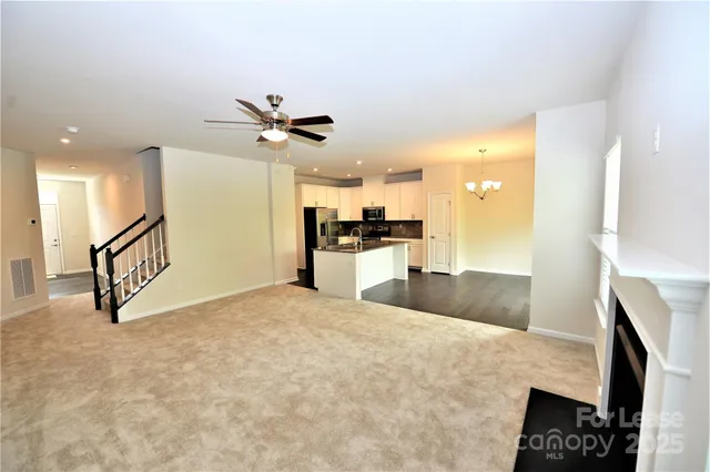 a view of a kitchen with a sink and a refrigerator