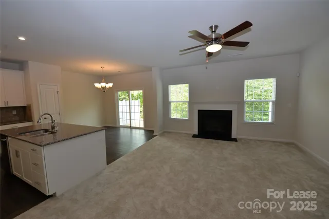 a kitchen with granite countertop a sink and a stove top oven