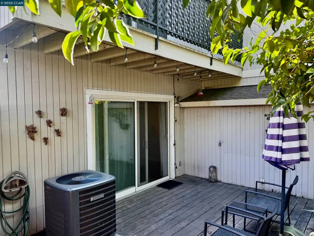 a backyard of a house with barbeque oven table and chairs