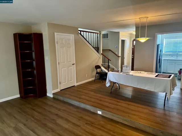 a view of room with furniture and wooden floor