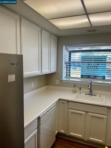 a kitchen with a sink cabinets and window