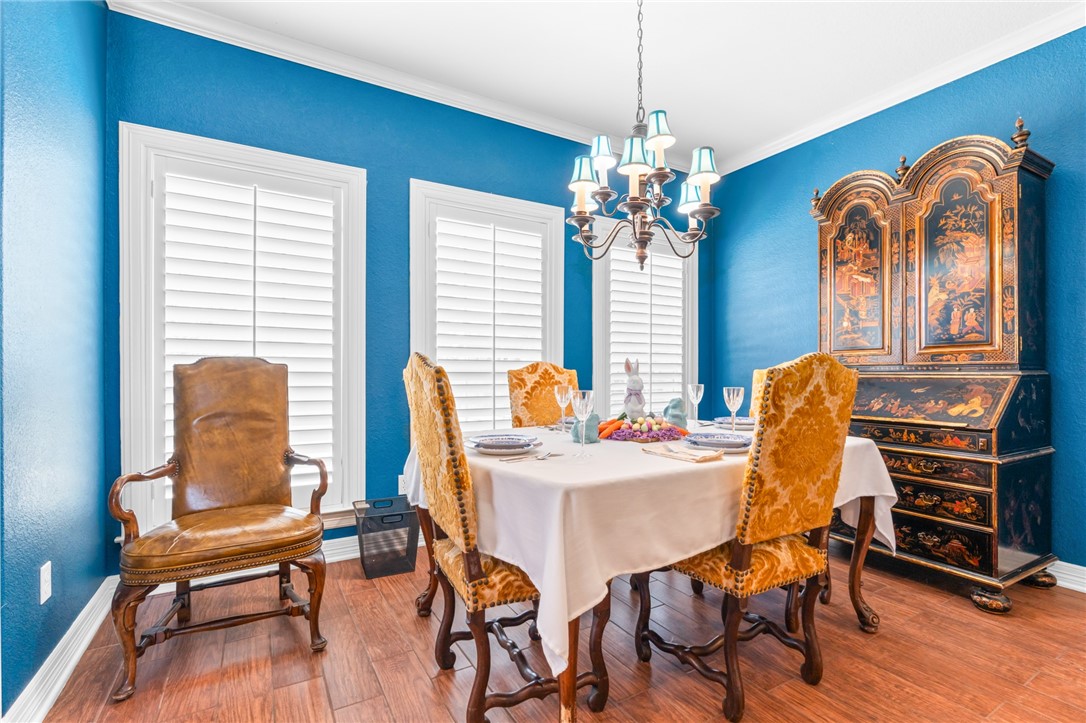 8 Republic Drive Waco, TX 76708 - Photo 22 of 42 a dining room with furniture a chandelier and wooden floor