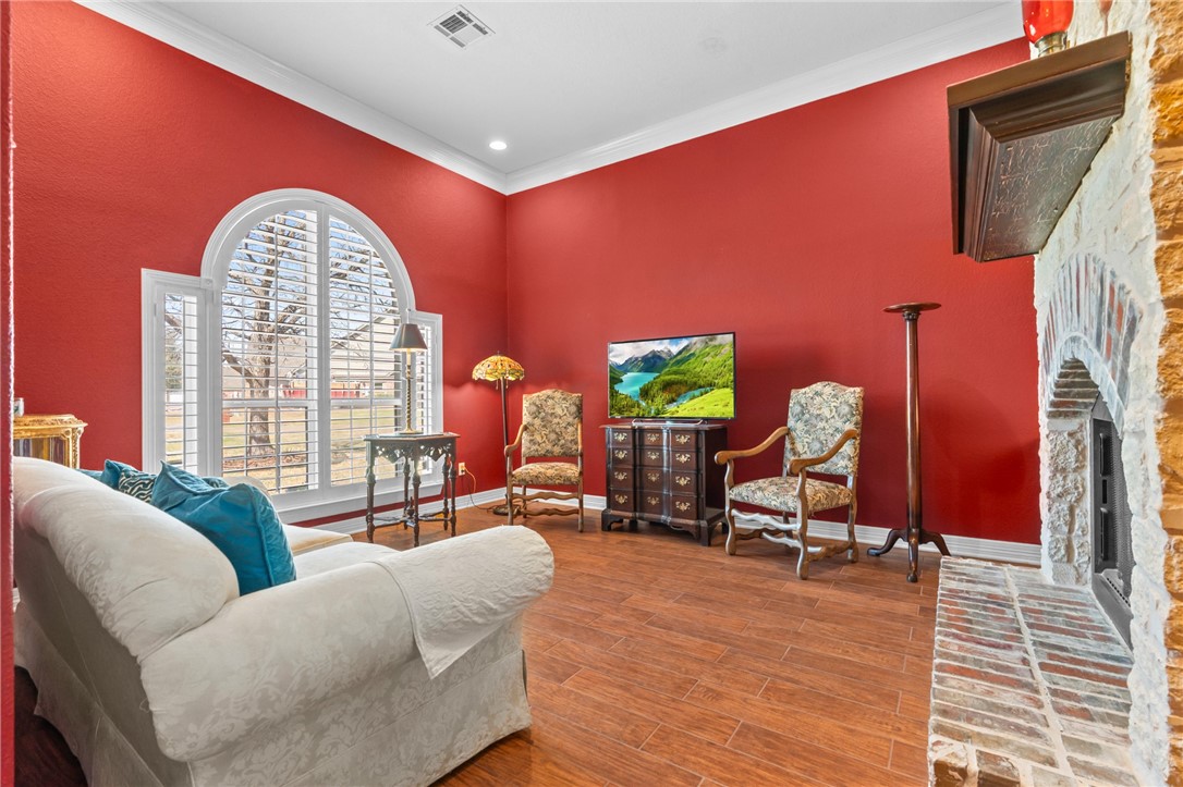 8 Republic Drive Waco, TX 76708 - Photo 27 of 42 a living room with furniture a fireplace and a floor to ceiling window