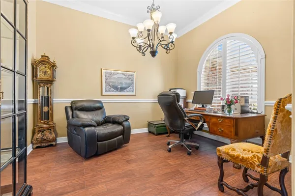 a living room with a bed furniture and a flat screen tv