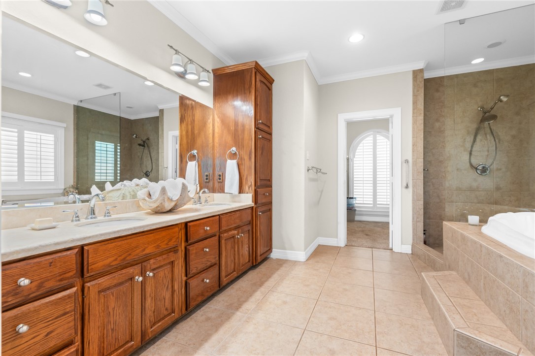 8 Republic Drive Waco, TX 76708 - Photo 32 of 42 a spacious bathroom with a mirror a double vanity sink and a mirror