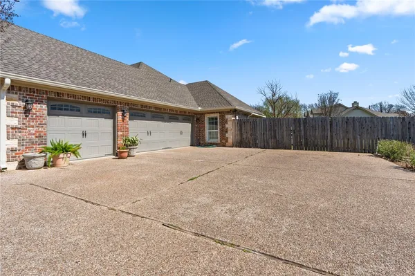 a view of a backyard with wooden fence