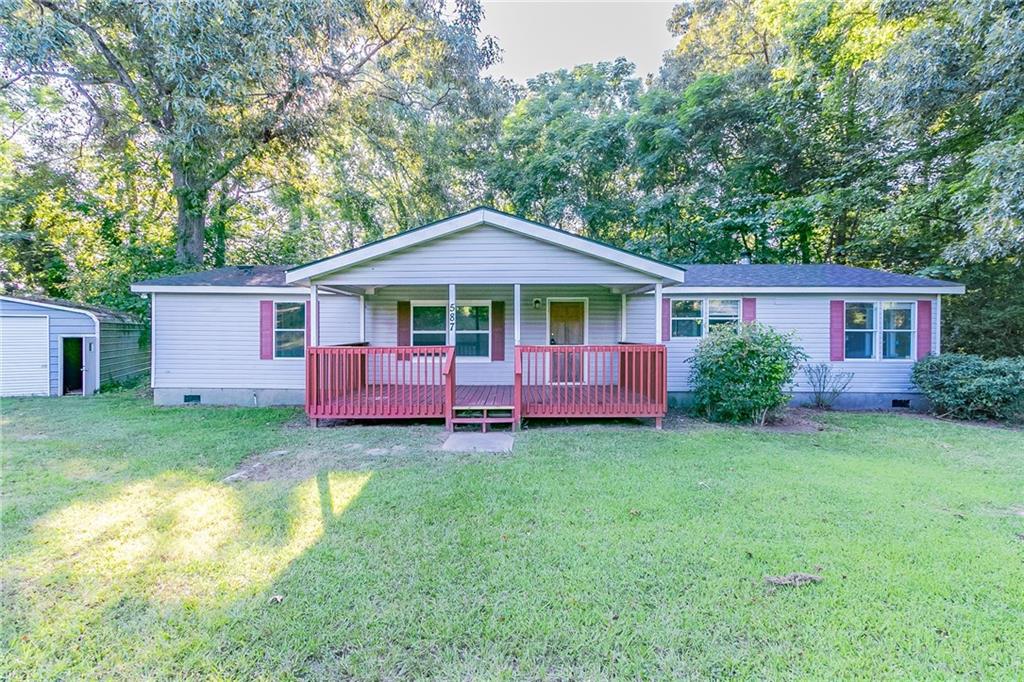 587 Swan Lake Road Stockbridge, GA 30281 - Photo 1 of 1 a front view of a house with a garden