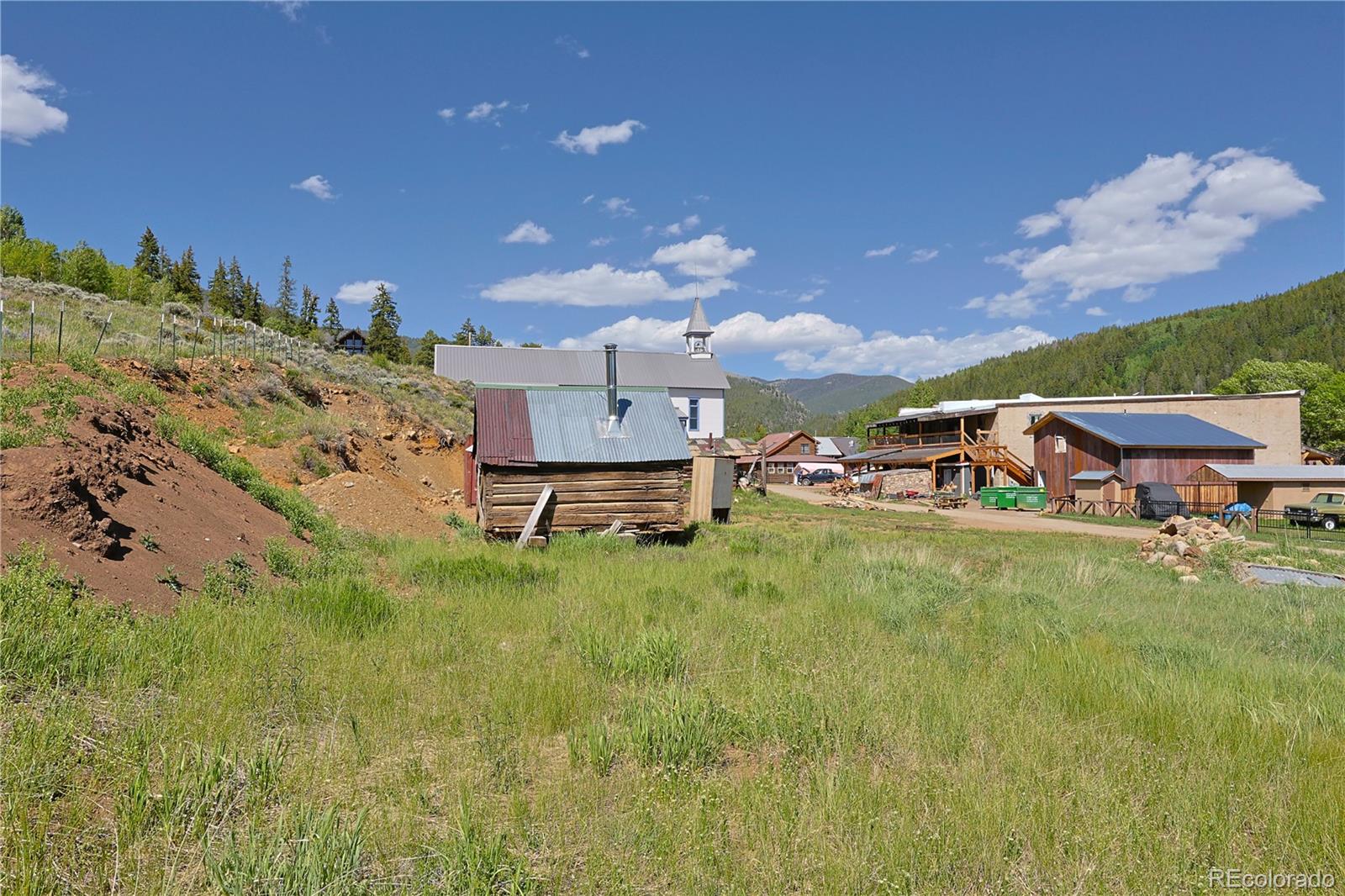 101 3rd Street Pitkin, CO 81241 - Photo 12 of 26 a backyard of a house with table and chairs