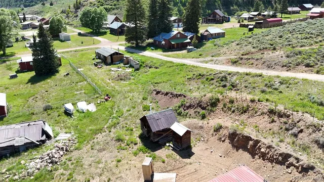 an aerial view of a house with garden space and street view