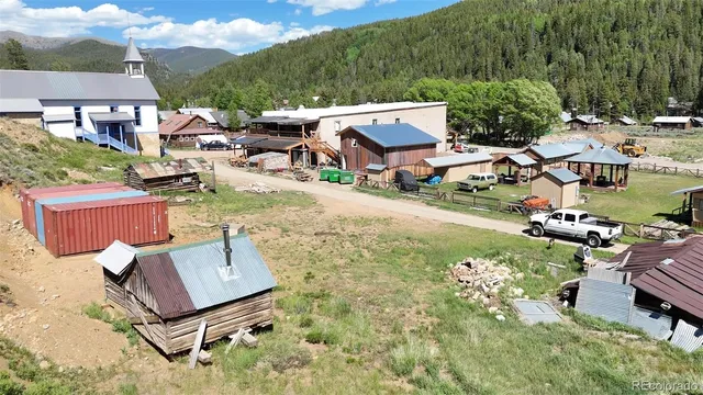 an aerial view of a house with a yard and lake view