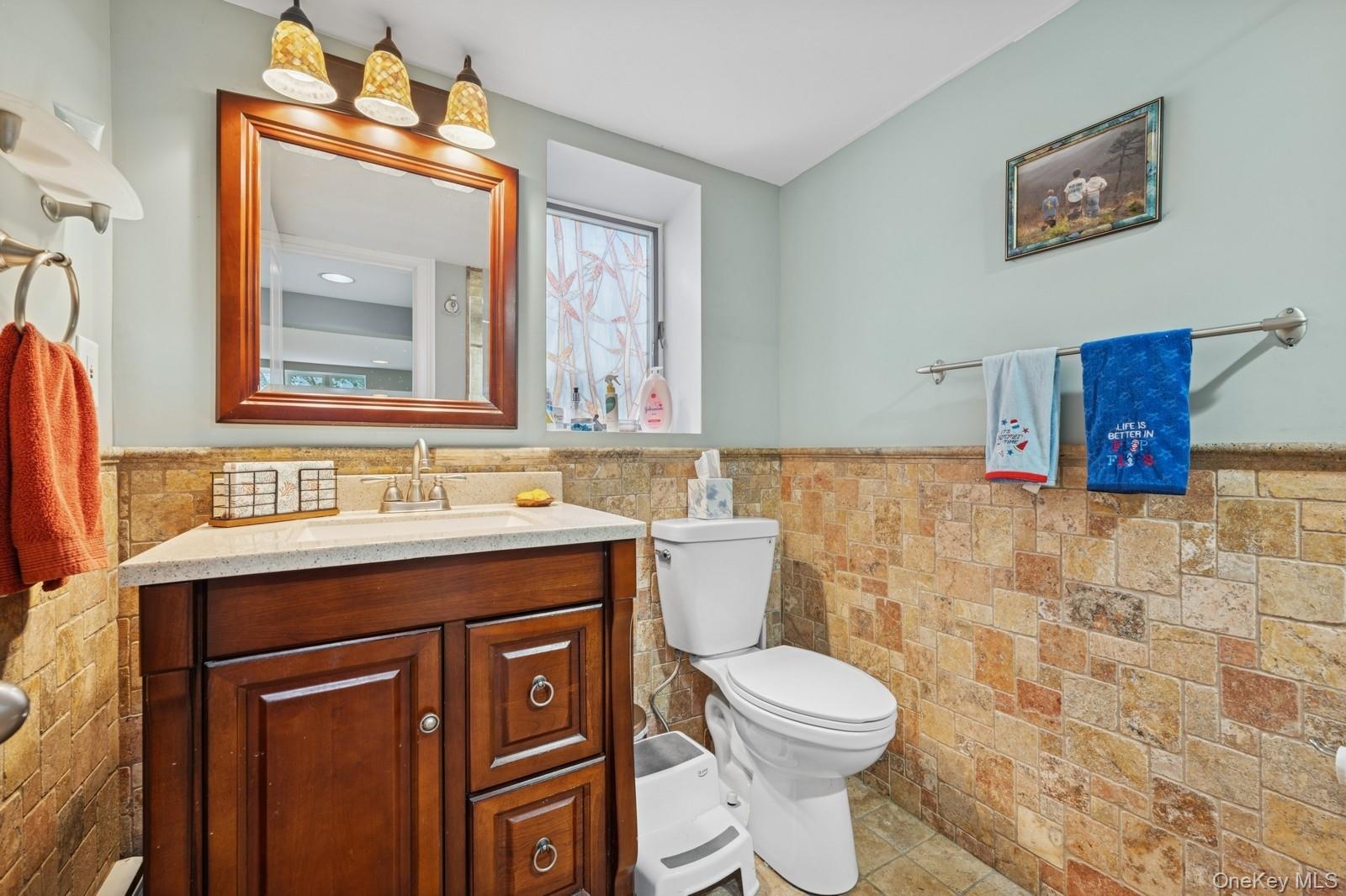 101 Bay Street Long Beach, NY 11561 - Photo 14 of 42 a bathroom with a toilet a sink and mirror