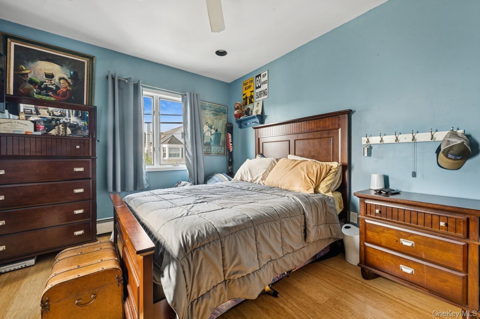 101 Bay Street Long Beach, NY 11561 - Photo 18 of 42 a bedroom with a bed and a dresser