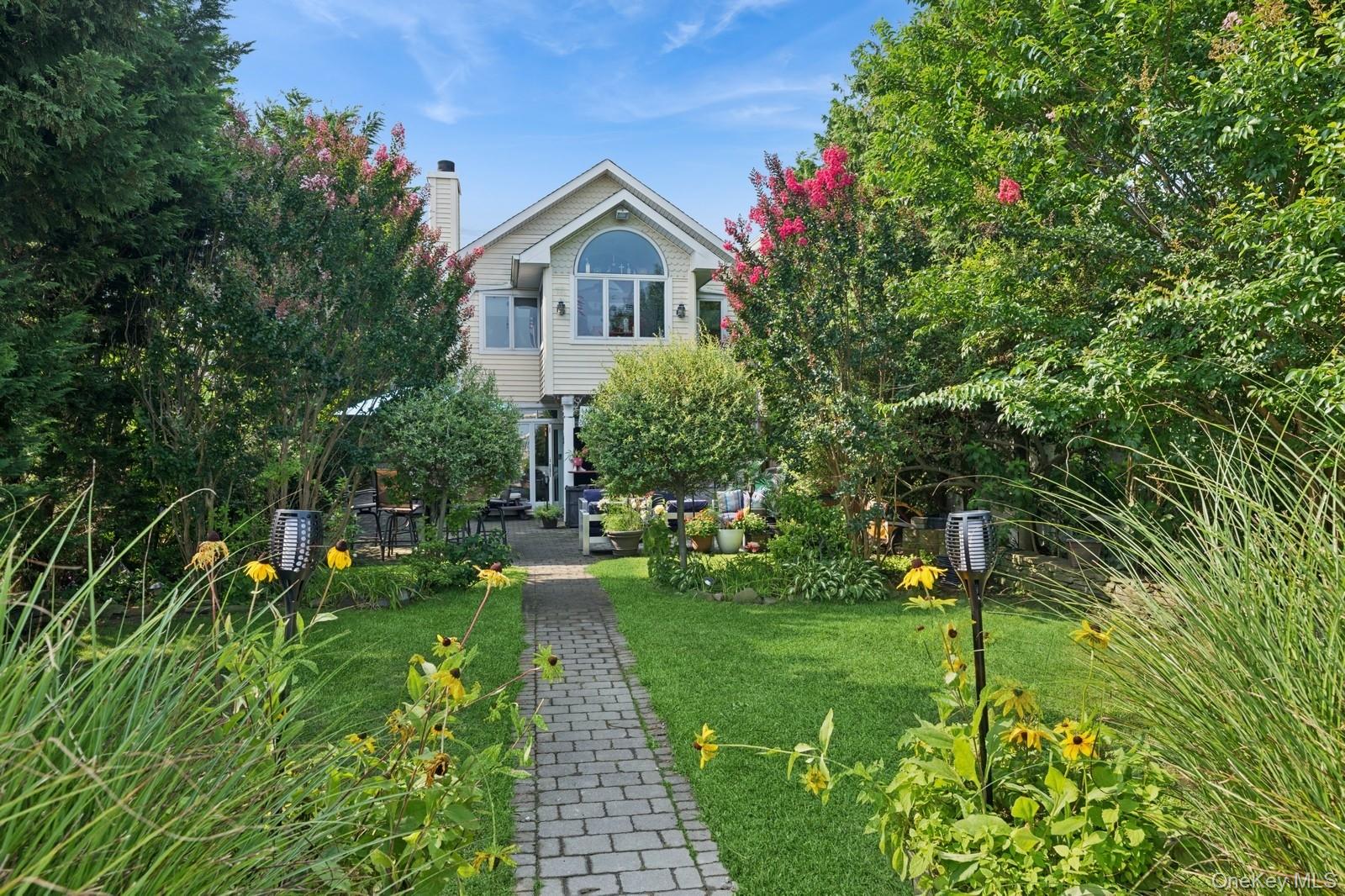 101 Bay Street Long Beach, NY 11561 - Photo 2 of 42 a view of a garden with a house in the background